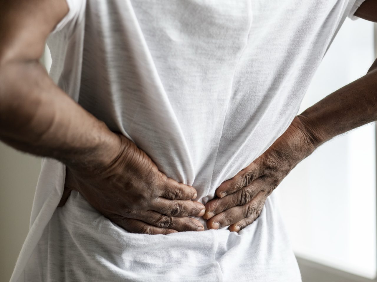 Advanced Health Solutions: Black man with back pain