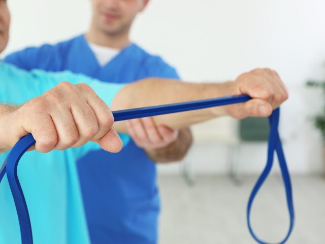 Advanced Health Solutions: physiotherapist working with a senior patient in rehabilitation